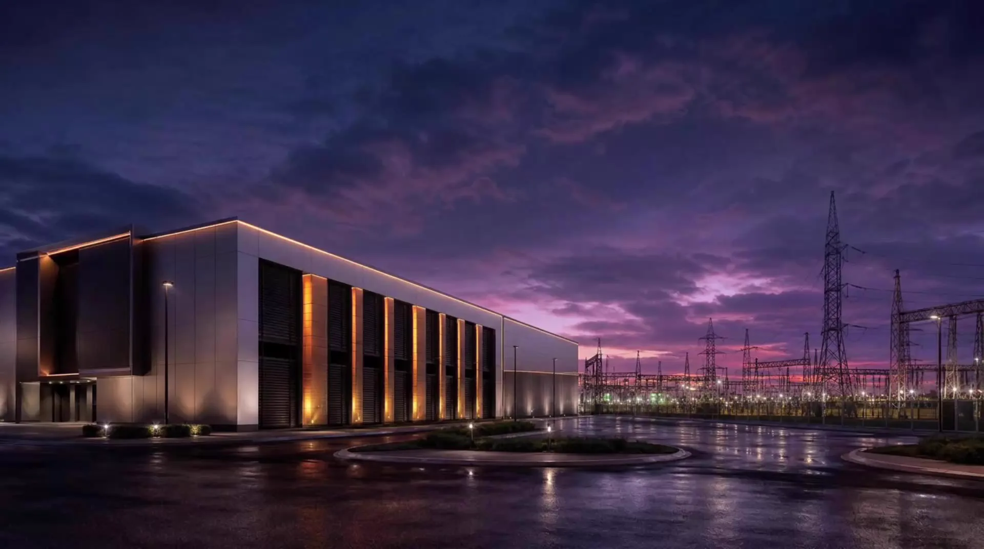 Modern data centre at twilight with high-voltage transmission infrastructure in the background